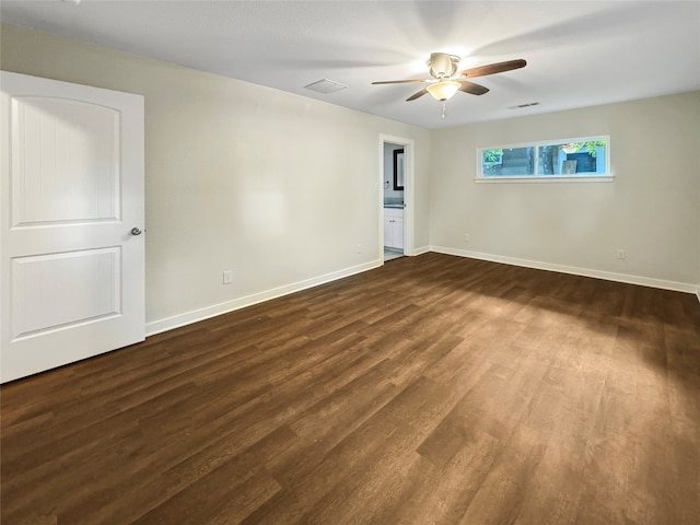 spare room featuring ceiling fan and dark hardwood / wood-style flooring