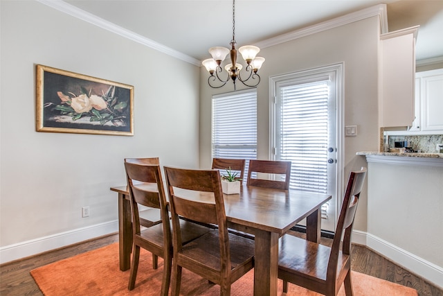 dining room with hardwood / wood-style flooring, a chandelier, and ornamental molding