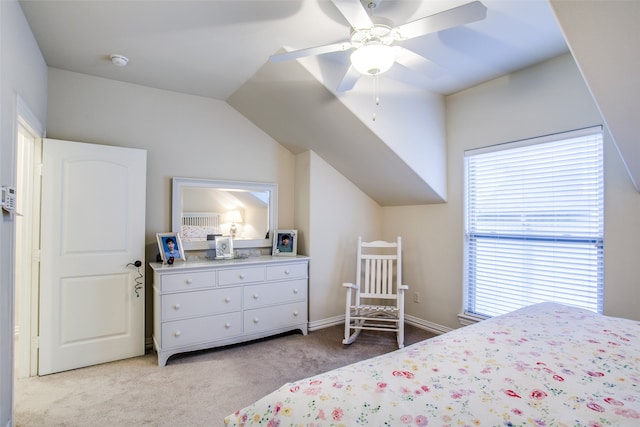 bedroom with lofted ceiling, ceiling fan, and light carpet