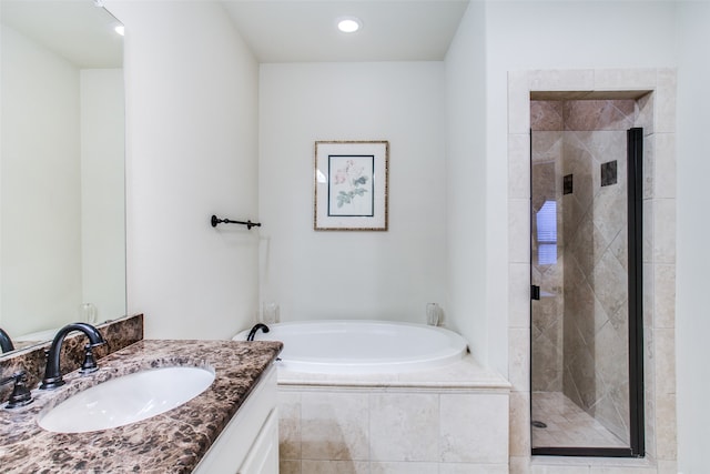 bathroom with vanity and separate shower and tub