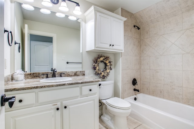 full bathroom with tiled shower / bath combo, vanity, toilet, and tile patterned floors