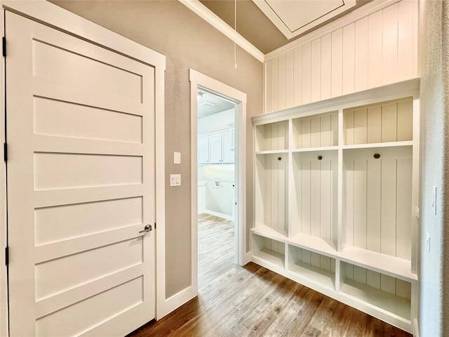 mudroom featuring hardwood / wood-style flooring and ornamental molding