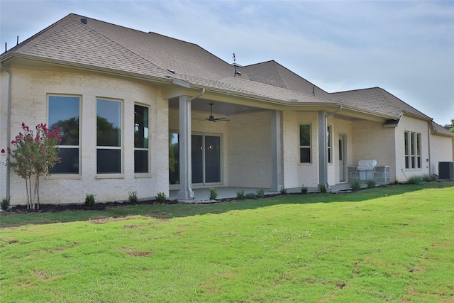 back of property featuring a yard, ceiling fan, and central air condition unit