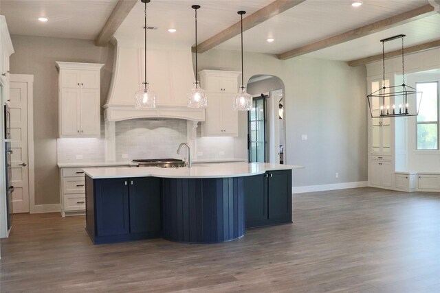 kitchen with white cabinetry, beamed ceiling, hardwood / wood-style flooring, and decorative light fixtures