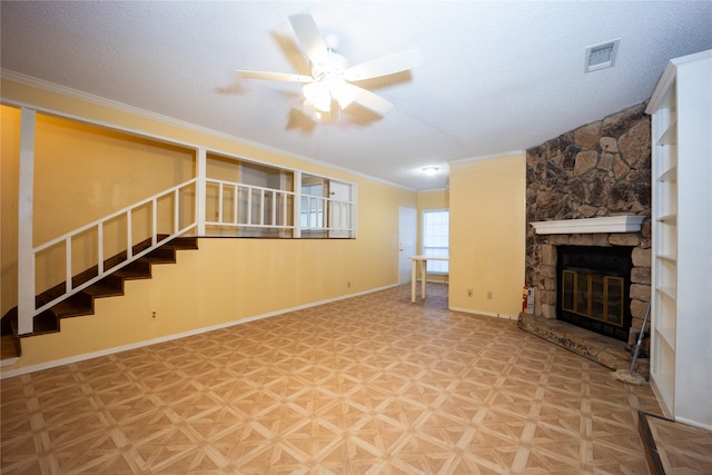 unfurnished living room featuring a fireplace, parquet floors, crown molding, a textured ceiling, and ceiling fan