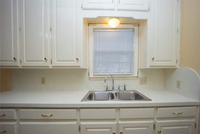 kitchen with white cabinetry and sink