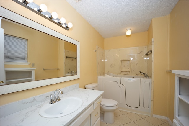 full bathroom featuring toilet, plus walk in shower, tile patterned flooring, vanity, and a textured ceiling