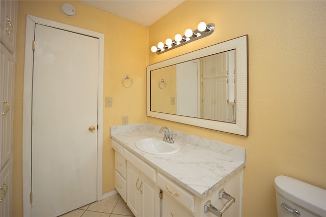 bathroom featuring vanity, toilet, and tile patterned floors