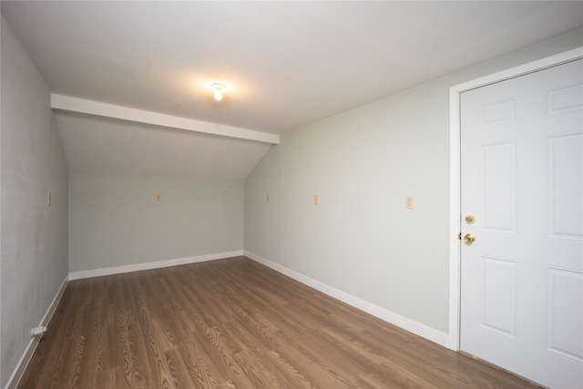 interior space featuring vaulted ceiling and dark hardwood / wood-style floors