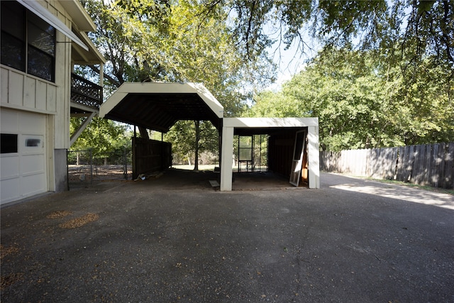 view of car parking with a garage and a carport