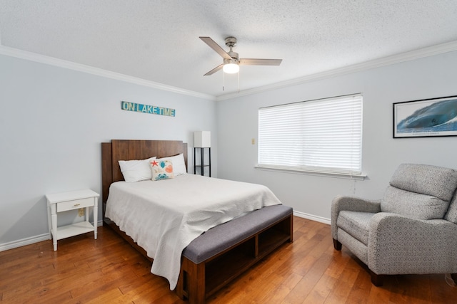 bedroom featuring ornamental molding, ceiling fan, and hardwood / wood-style floors