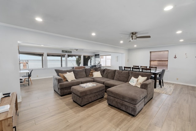 living room with a water view, light hardwood / wood-style floors, ornamental molding, and ceiling fan