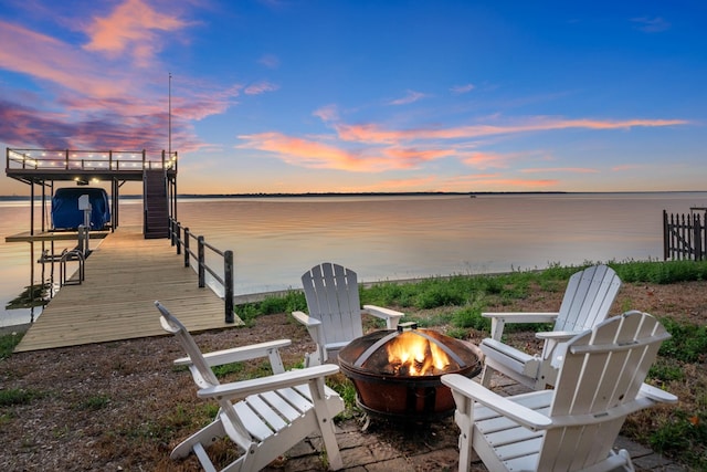 dock area with a water view and an outdoor fire pit