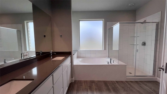 bathroom featuring vanity, hardwood / wood-style flooring, and shower with separate bathtub