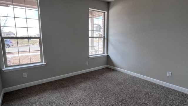 empty room with plenty of natural light and carpet