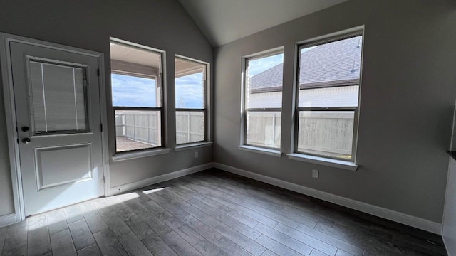 empty room with lofted ceiling and dark hardwood / wood-style flooring