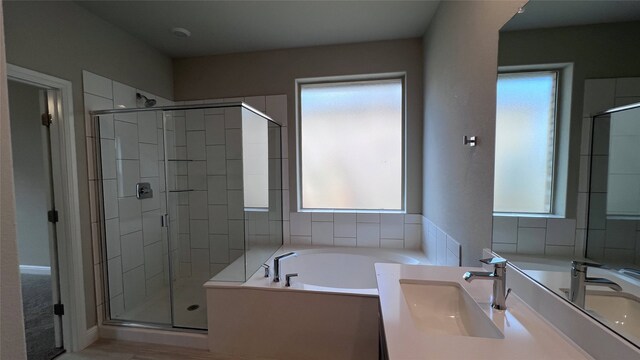 bathroom featuring vanity, wood-type flooring, and independent shower and bath