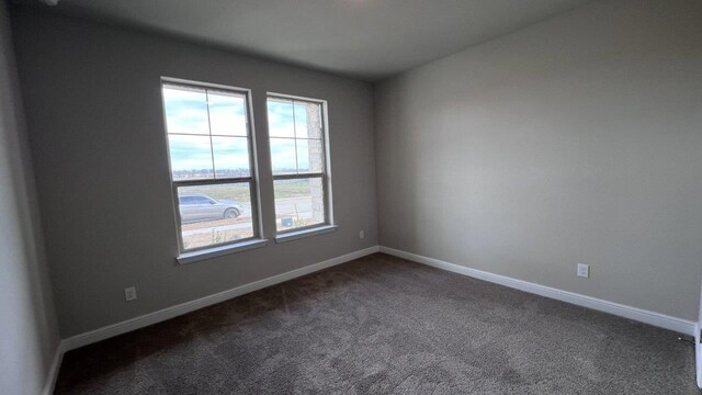 carpeted bedroom featuring multiple windows and lofted ceiling