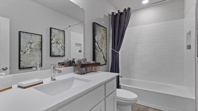 full bathroom featuring toilet, hardwood / wood-style flooring, vanity, and shower / tub combo with curtain