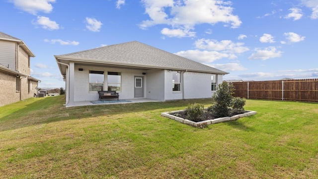 back of property featuring a patio area and a yard