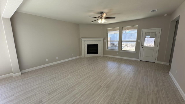 unfurnished living room with ceiling fan and light hardwood / wood-style floors