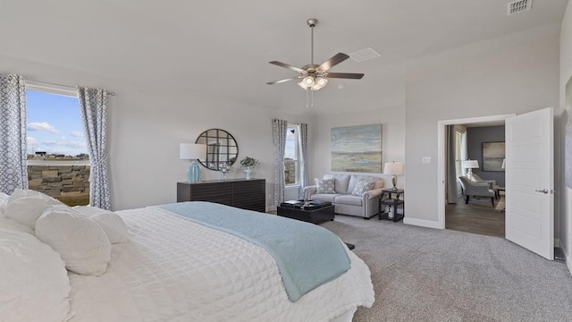 bedroom featuring ceiling fan, multiple windows, and carpet