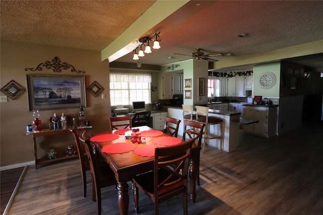 dining room featuring a textured ceiling, dark hardwood / wood-style flooring, ceiling fan, and sink