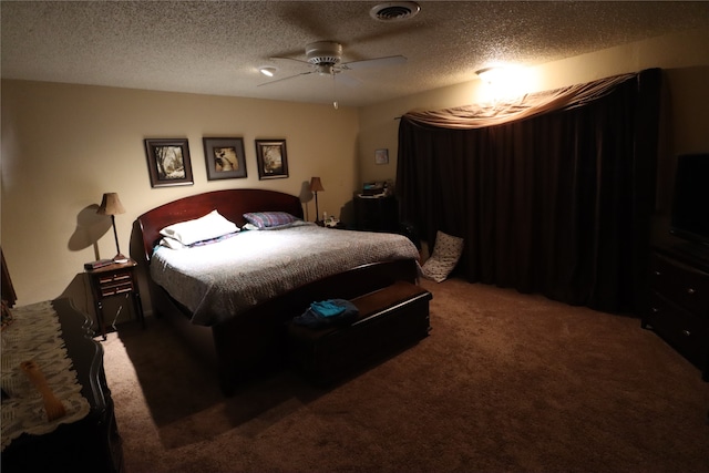 bedroom featuring ceiling fan, a textured ceiling, and dark carpet