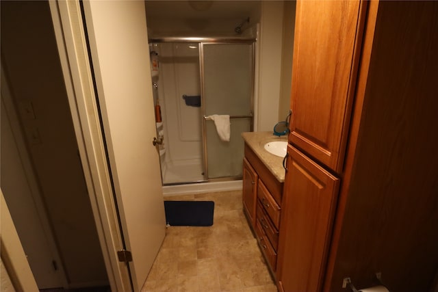 bathroom with walk in shower and vanity