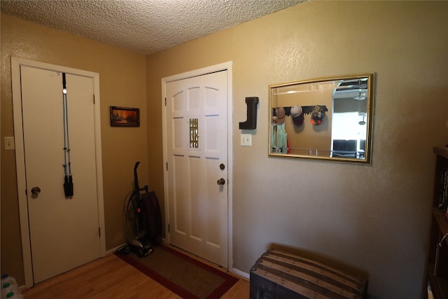 foyer with a textured ceiling and hardwood / wood-style floors