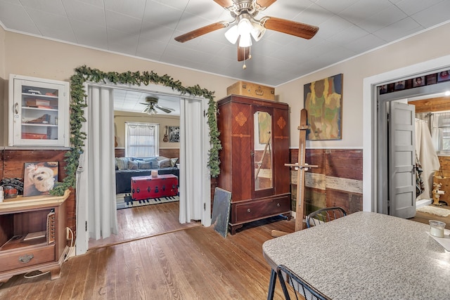 interior space featuring ornamental molding, ceiling fan, and hardwood / wood-style flooring