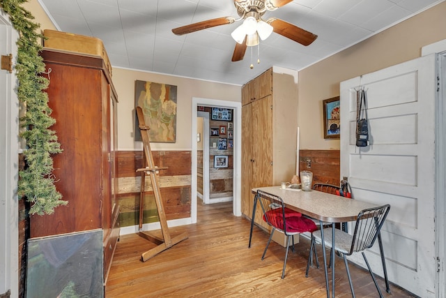 dining space with light wood-type flooring and ceiling fan