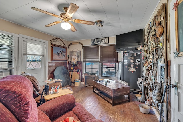 living room with hardwood / wood-style floors, ceiling fan, and a wealth of natural light