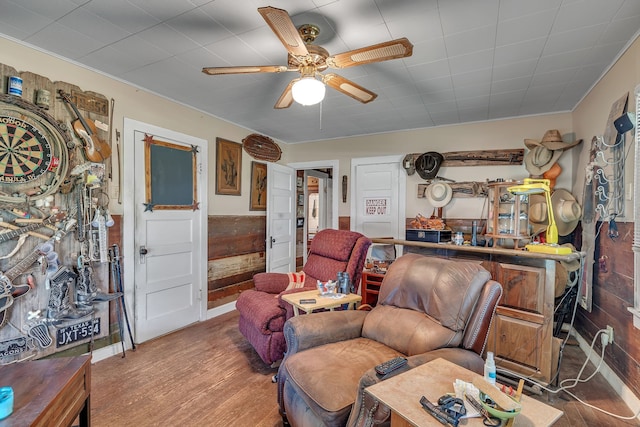 living room featuring ceiling fan and hardwood / wood-style flooring