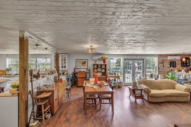 dining area with wood-type flooring, french doors, and a wall mounted air conditioner