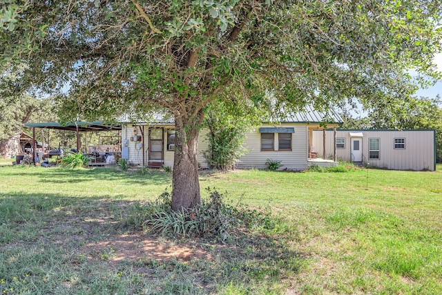 view of front facade with a front yard and a shed