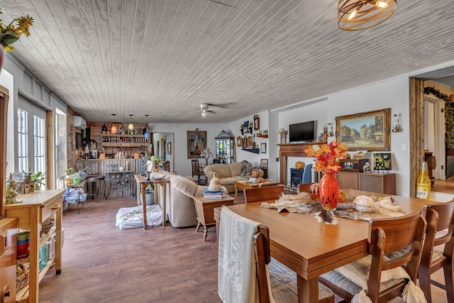 dining room featuring wooden ceiling, bar, hardwood / wood-style floors, and ceiling fan