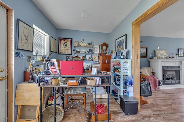 office area featuring wood-type flooring and vaulted ceiling