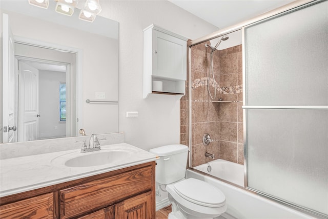 full bathroom with shower / bath combination with glass door, toilet, and vanity