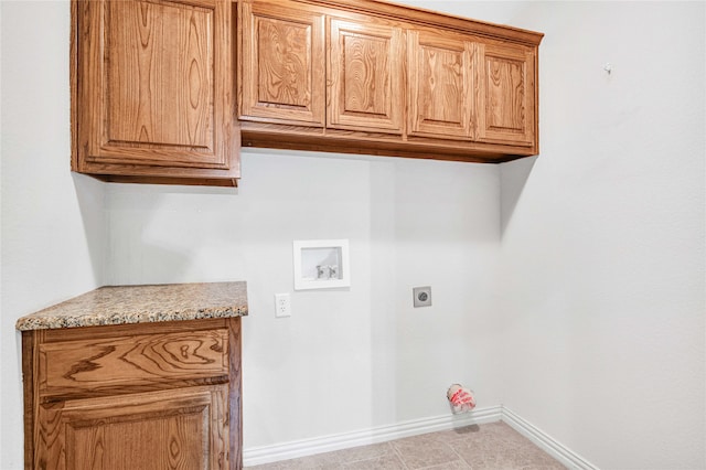 clothes washing area with hookup for a washing machine, light tile patterned floors, hookup for an electric dryer, and cabinets