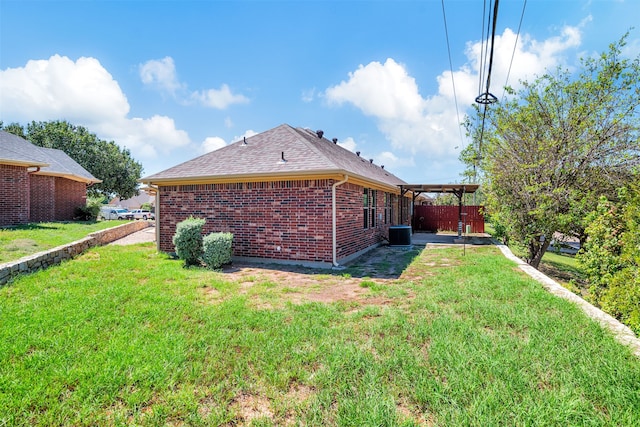 exterior space featuring cooling unit and a lawn