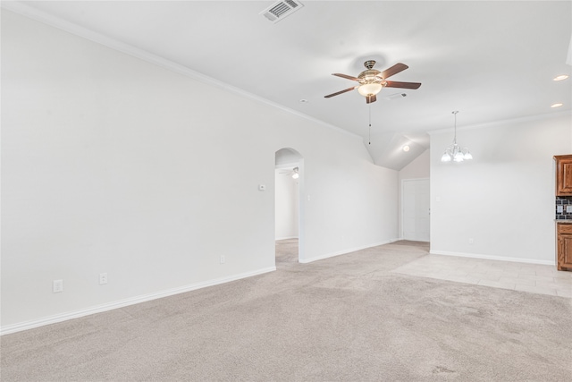 carpeted empty room with lofted ceiling, ceiling fan with notable chandelier, and ornamental molding