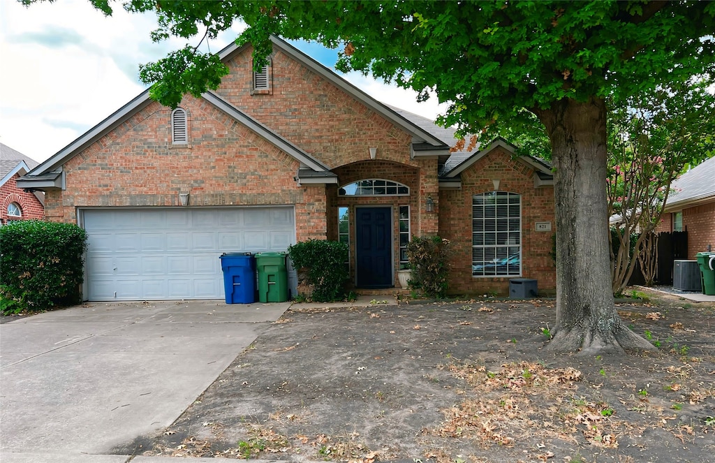 front of property featuring a garage and central AC unit