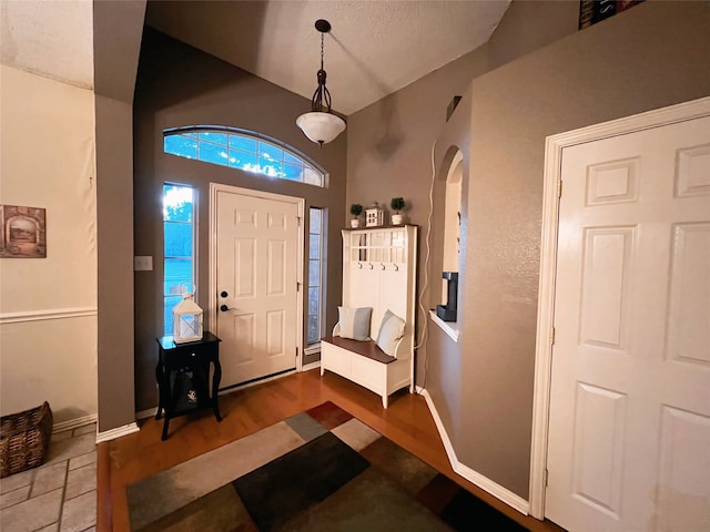 foyer entrance with wood-type flooring and a textured ceiling