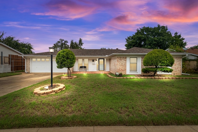 ranch-style home featuring a yard and a garage