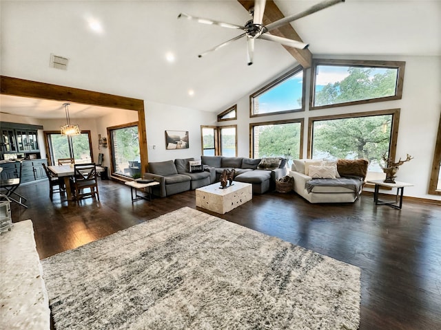 living room featuring dark wood-type flooring, ceiling fan, high vaulted ceiling, and beam ceiling