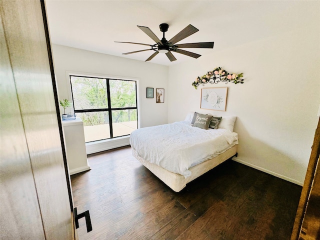 bedroom featuring a baseboard radiator, ceiling fan, and dark hardwood / wood-style floors