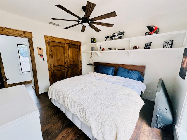 bedroom with ceiling fan and dark hardwood / wood-style floors