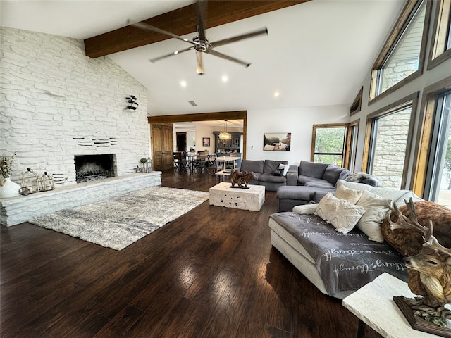 living room with dark hardwood / wood-style floors, a fireplace, beam ceiling, high vaulted ceiling, and ceiling fan