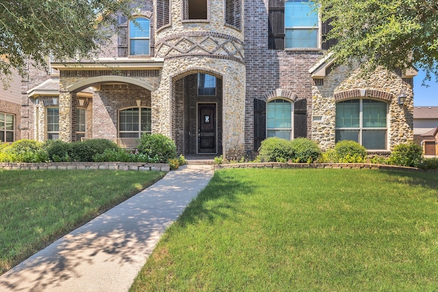 doorway to property featuring a lawn